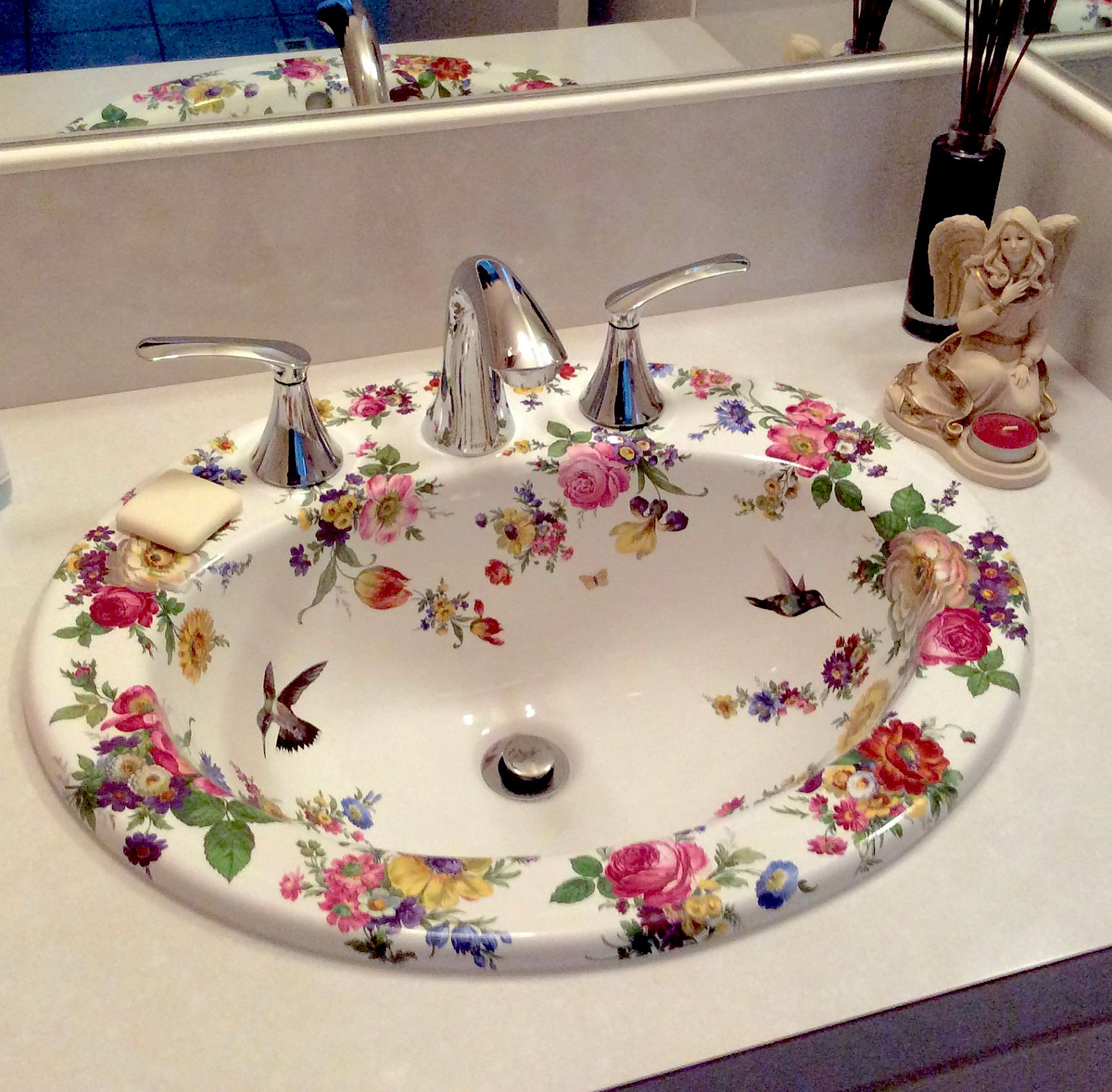 hand painted sink in bathroom with flowers and hummingbirds